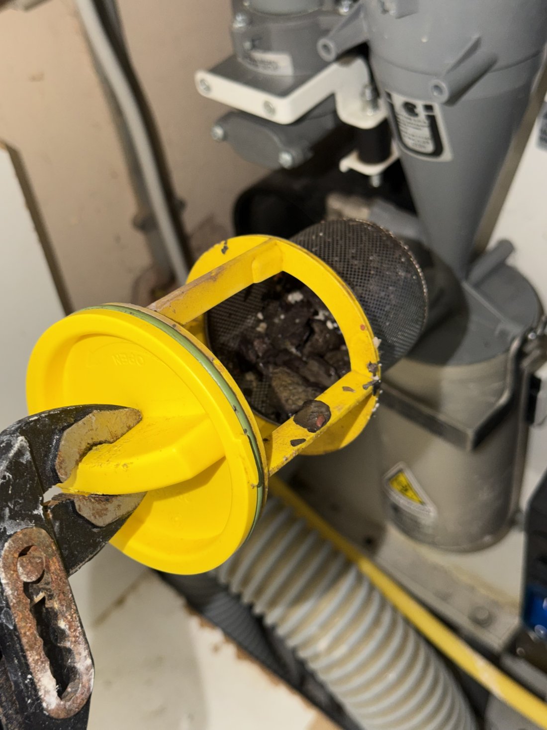 Clearing a clogged dental suction filter during planned preventive maintenance